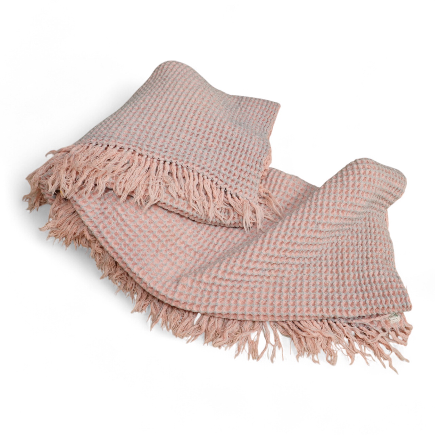 A pink and grey Welsh blanket with tasseled edges